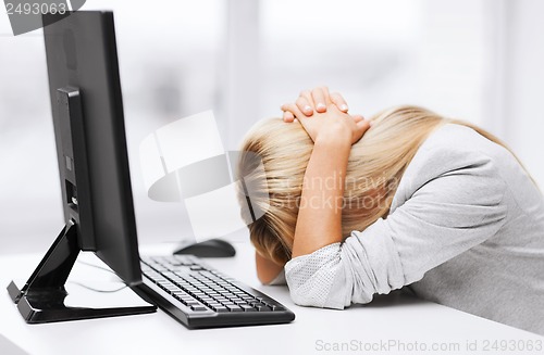 Image of stressed woman with computer