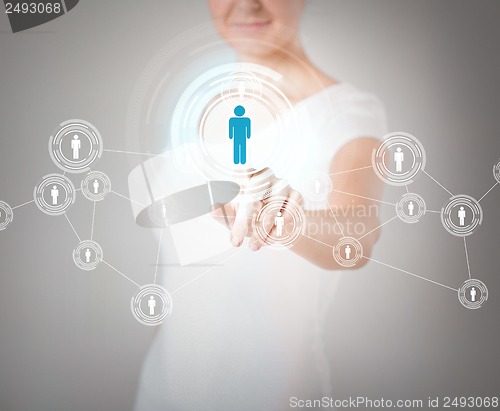 Image of businesswoman pressing button with contact