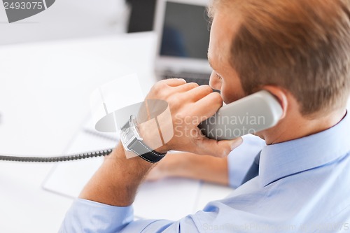 Image of handsome businessman talking on the phone
