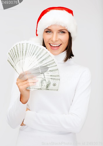 Image of woman in santa helper hat with us dollar money