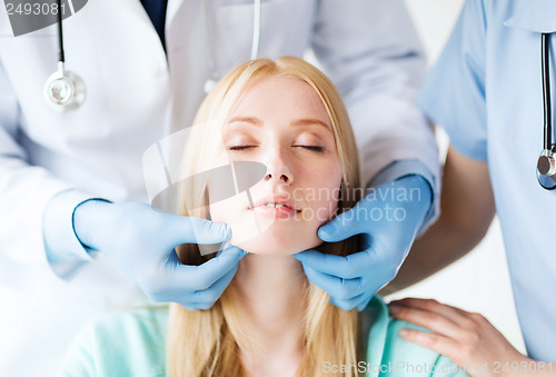 Image of plastic surgeon or doctor with patient