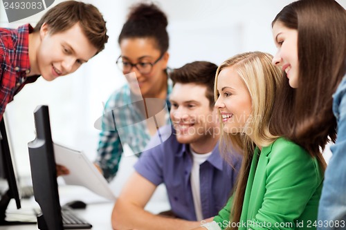 Image of students looking at computer monitor at school