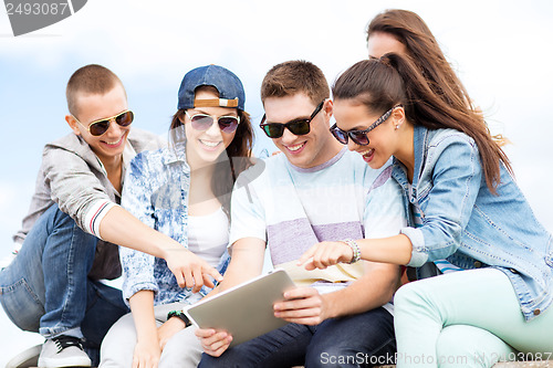 Image of group of teenagers looking at tablet pc