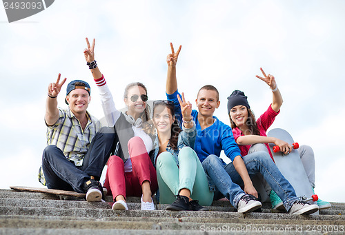 Image of group of teenagers showing finger five