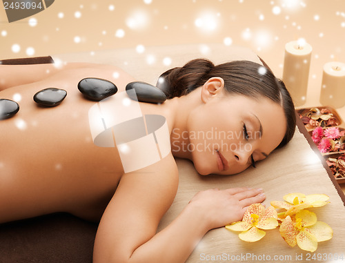 Image of beautiful woman with hot stones