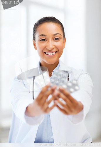 Image of doctor with blister packs of pills