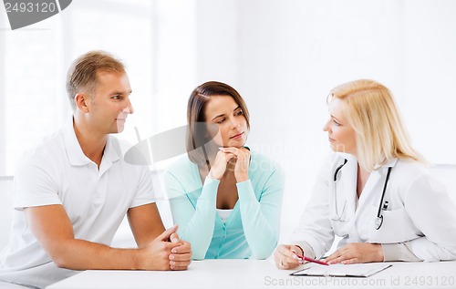 Image of doctor with patients in cabinet