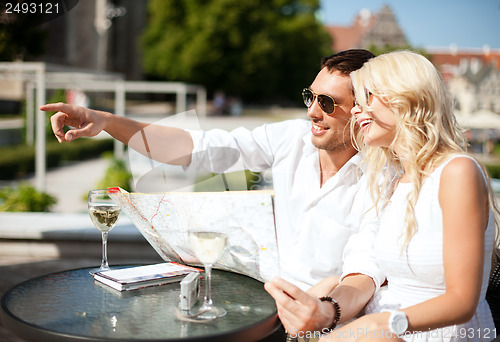 Image of couple with map in cafe