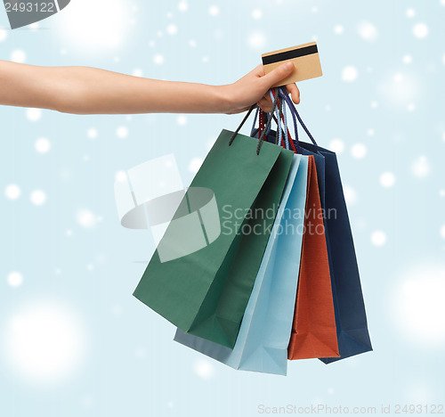 Image of woman with shopping bags and credit card