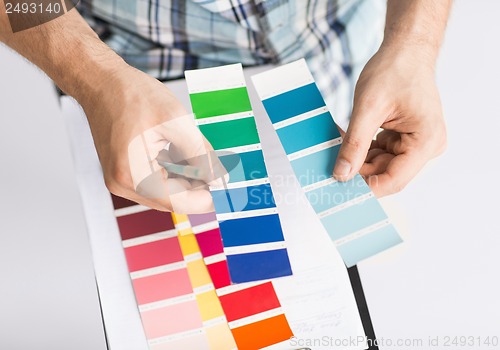Image of man with color samples for selection