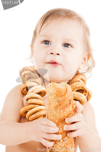 Image of cute todler eating long bread