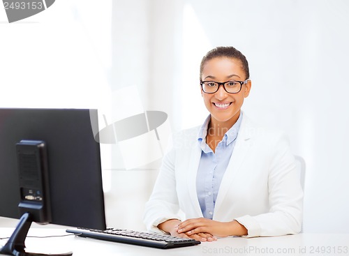 Image of african businesswoman with computer in office