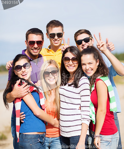 Image of group of friends having fun on the beach