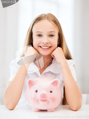 Image of child with piggy bank