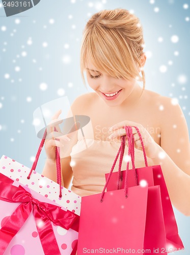 Image of happy teenage girl with many shopping bags