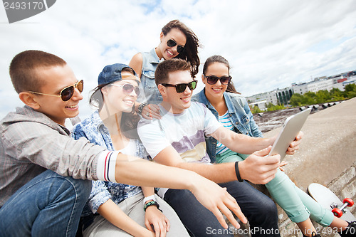 Image of group of teenagers looking at tablet pc