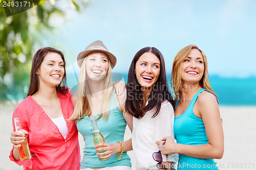 Image of girls with drinks on the beach