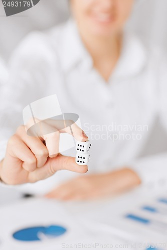 Image of man hands with gambling dices signing contract