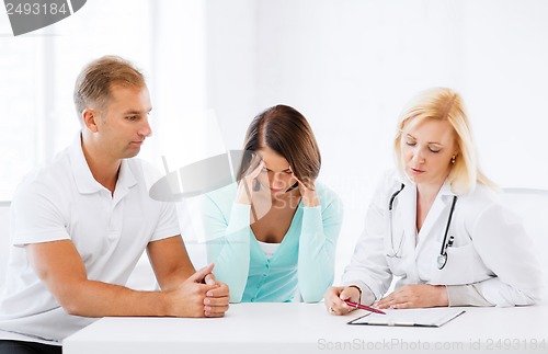 Image of doctor with patients in cabinet