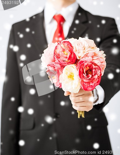 Image of man giving bouquet of flowers