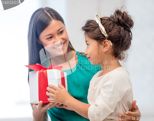 Image of happy mother and child girl with gift box