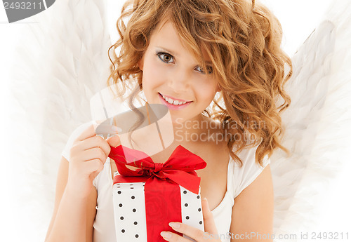 Image of happy teenage angel girl with christmas gift