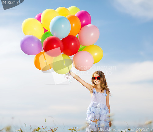 Image of happy girl with colorful balloons