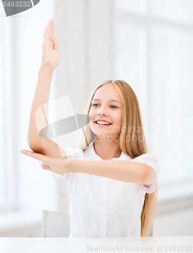 Image of student girl with hand up at school