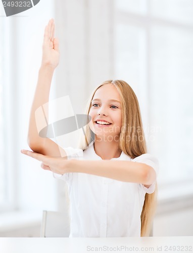 Image of student girl with hand up at school