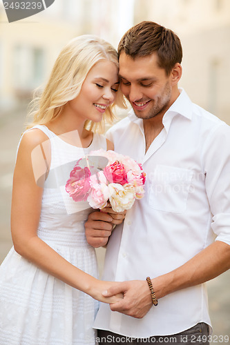 Image of couple with flowers in the city