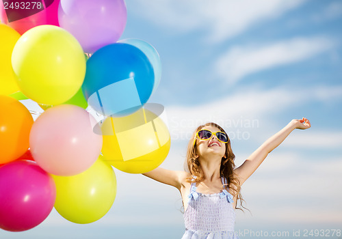 Image of happy girl with colorful balloons