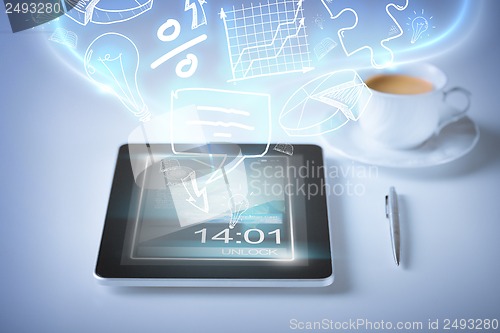Image of tablet pc with icons and coffee