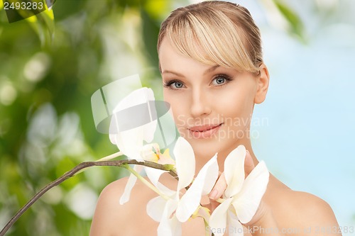 Image of beautiful woman with orchid flower