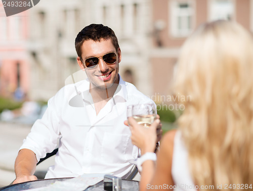 Image of couple drinking wine in cafe