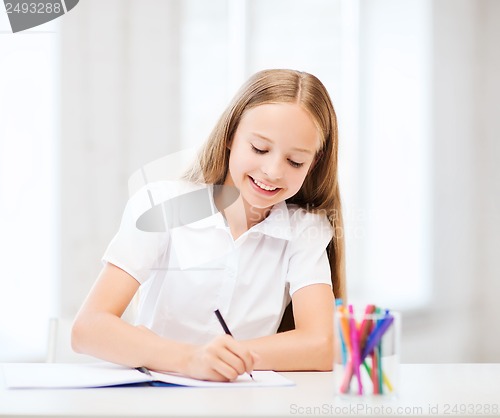 Image of little student girl drawing at school