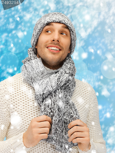 Image of handsome man in warm sweater, hat and scarf