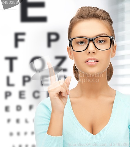 Image of woman in eyeglasses with eye chart