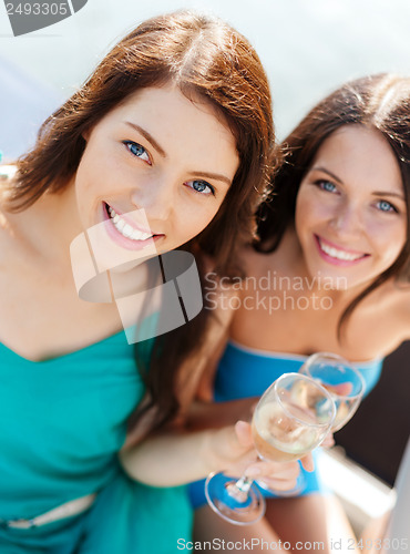 Image of girls with champagne glasses on boat