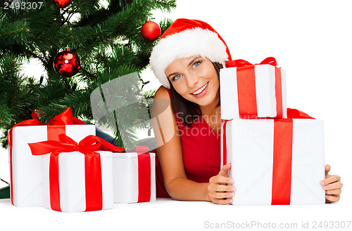 Image of smiling woman in santa helper hat with gift boxes