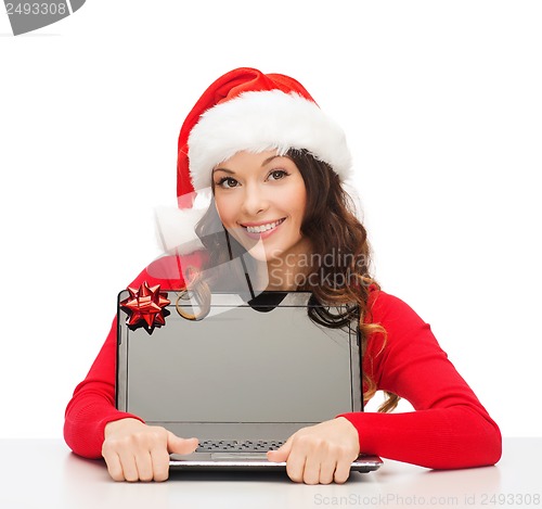 Image of woman in santa helper hat with laptop computer