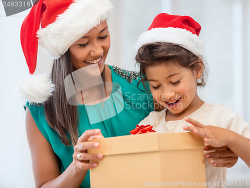 Image of happy mother and child girl with gift box