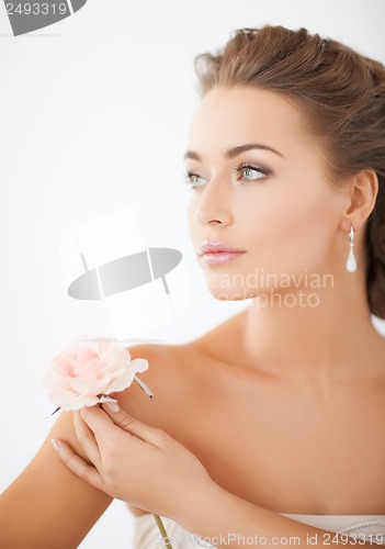 Image of young woman with rose flower