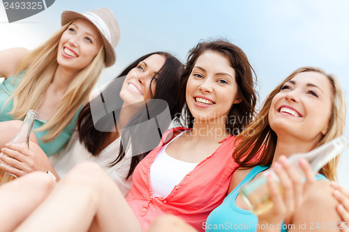 Image of girls with drinks on the beach