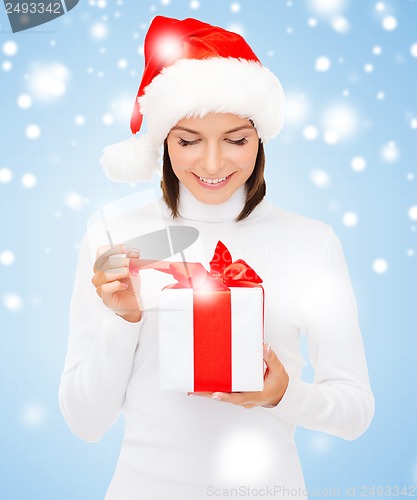 Image of smiling woman in santa helper hat with gift box