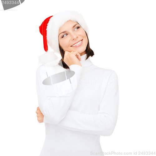 Image of thinking and smiling woman in santa helper hat