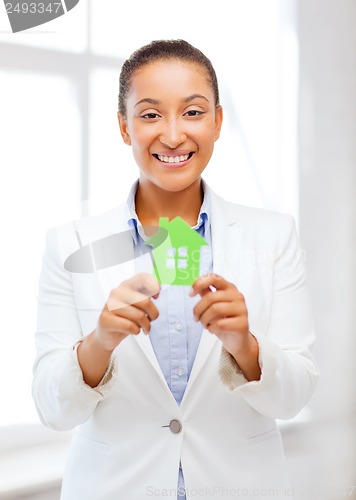 Image of african woman holding green paper house