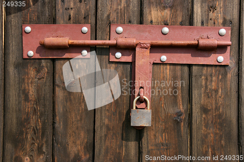 Image of Old padlock on wooden door