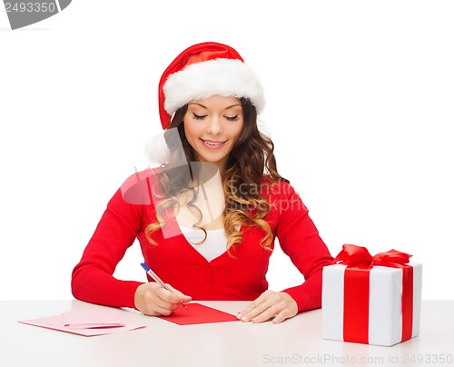 Image of smiling woman in santa helper hat with postcard