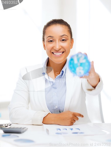 Image of businesswoman working with calculator in office