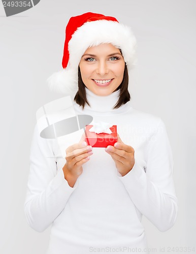 Image of smiling woman in santa hat with small gift box